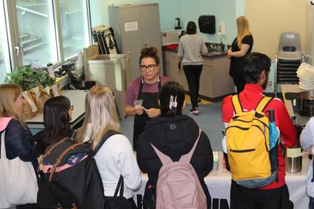 Leah serves food to students