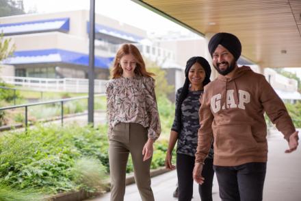 Three students walk by the Health and Science Centre