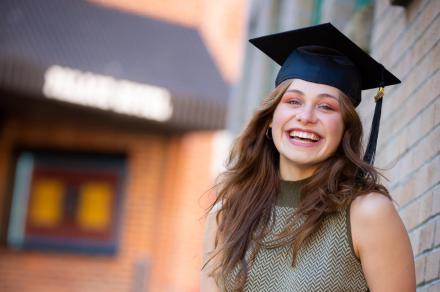 Portrait shot of Lurana wearing a grad cap