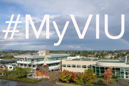 Picture of VIU's Nanaimo campus with a rainbow going across